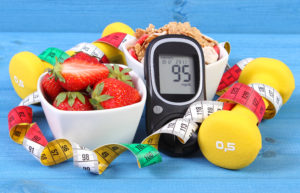 Glucometer with sugar level, healthy food, dumbbells and centimeter, diabetes, healthy and sporty lifestyle